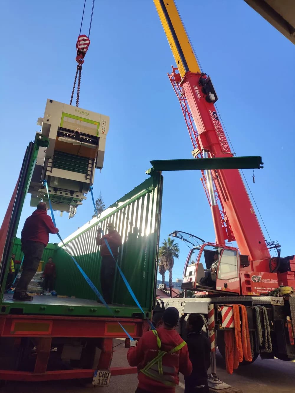 Crane lifting machinery into shipping container at Malta Freeport